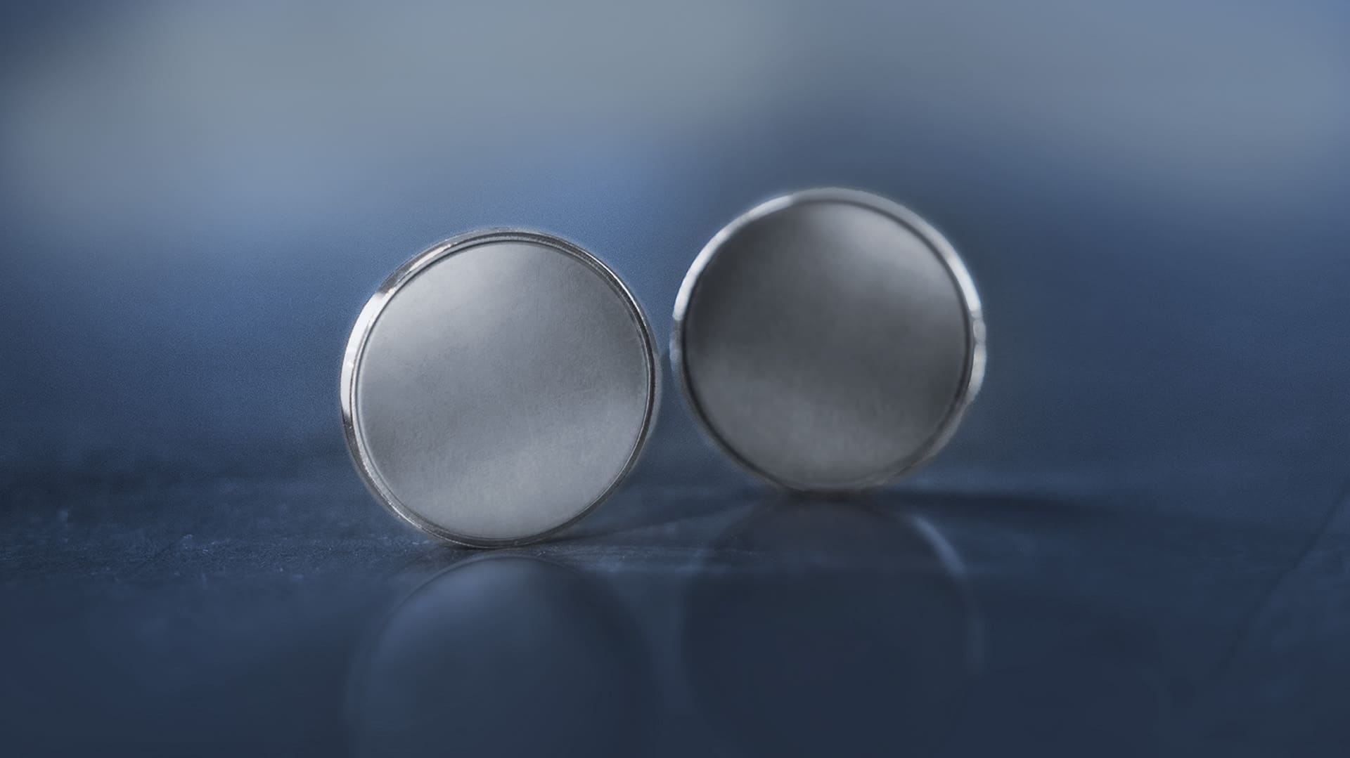 Münzrohling vor blau-grauen Hintergrund Münzrohling vor blau-grauen Hintergrund